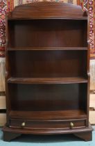 A 20th century mahogany bow front waterfall bookcase with three open shelves over single drawer on