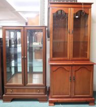 A lot comprising a cotemporary two door glazed display cabinet, 140cm high x 81cm wide x 37cm deep
