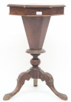 A Victorian walnut trumpet form sewing/games table with octagonal inlaid top concealing fitted