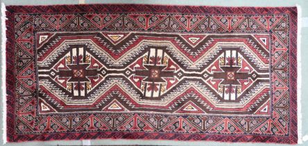 A multicoloured ground fine handwoven Persian Baluchi nomadic rug with geometric patterned ground