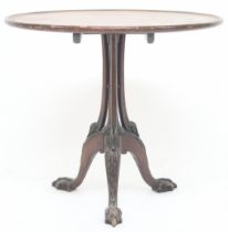 A 19th century mahogany circular tilt topped occasional table on clustered column support on