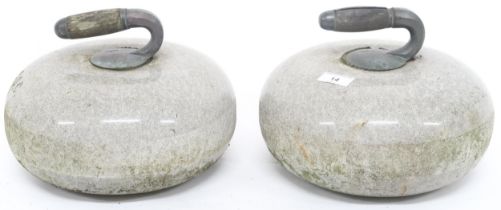 A pair of 19th century Scottish curling stones with steel and wood handles on granite stones most