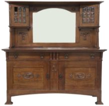 AN  OAK ARTS & CRAFTS MIRROR BACK SIDEBOARD  bevelled mirror back flanked by glazed cabinets on