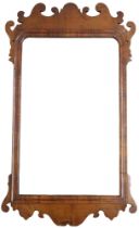 A GEORGIAN WALNUT VENEERED WALL MIRROR with fret cut scrolled frame, 94cm high x 55cm wide Condition