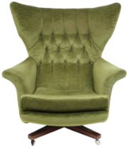 A MID 20TH CENTURY G PLAN MODEL 62 "BLOFELD" SWIVEL ARMCHAIR  with green velour button backed