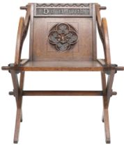A 19TH CENTURY OAK PUGINESQUE STYLE GLASTONBURY CHAIR  backrest and arms carved with bible verse
