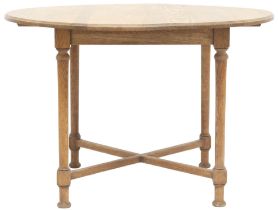 AN OAK ARTS & CRAFTS BREAKFAST TABLE  with circular top on turned supports joined by crossed