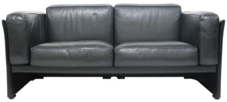 A 20TH CENTURY CASSINA TWO SEATER SETTEE with black leather upholstered cushions on leather