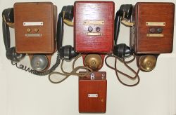 A trio of wood cased signal box Telephones with side mounted bakelite handsets, dual select