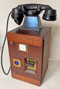 An unusual wood cased Signal Box Telephone with bakelite handset in top cradle. The front has a