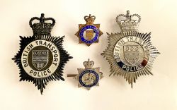 A pair of British Transport Police Helmet Badges, one blackened the other plain. Together with two