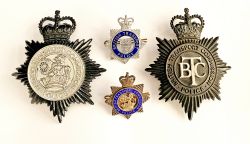 A pair of British Transport Police Helmet Badges, one blackened showing the earlier BTC centre