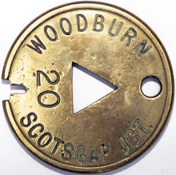 Tyers No 5 brass single line tablet, WOODBURN - SCOTSGAP JCT. Measures 3.875in diameter, in ex