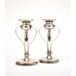 A pair of early 20th century silver candlesticks