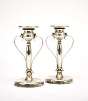 A pair of early 20th century silver candlesticks