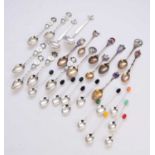 A collection of silver and white metal spoons