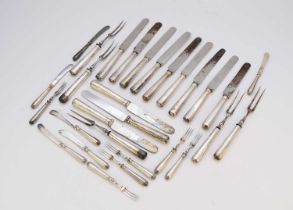 A collection of silver handled knives and forks