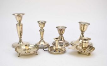 A collection of seven silver candlesticks