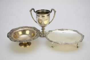 A silver two handle trophy cup and two silver dishes