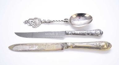 A continental silver decorative spoon and two cake knives