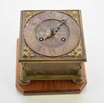 A reproduction brass horizontal table clock