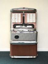 An Ami Jukebox Model JBH-120, with a collection of 45rpm singles
