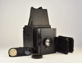 A half plate camera with wood tripod, developing tank and dark plates