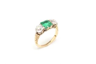 A late 19th / early 20th century three stone emerald and diamond ring