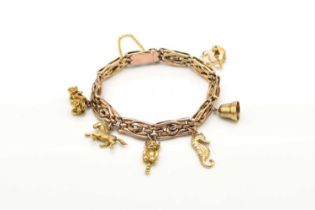 A rose metal decorative link bracelet with attached charms