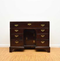 A George III mahogany veneered campaign type kneehole desk