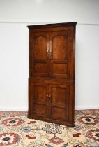 A George III oak standing corner cabinet