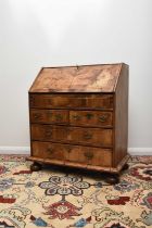 A Queen Anne style walnut and feather banded bureau