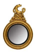 A Regency giltwood and parcel ebonised convex mirror