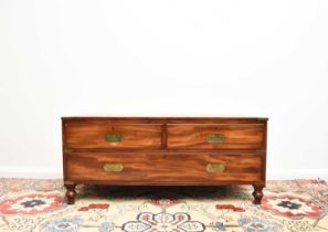 A reproduction campaign type coffee table chest