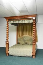 A mahogany four-poster bed in the George III style