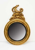 A Regency giltwood and parcel ebonised convex mirror