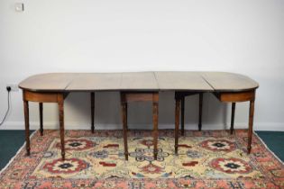 A George III mahogany D-end extending dining table