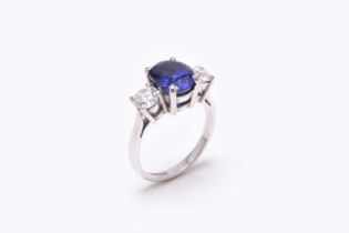 An 18ct white gold three stone sapphire and diamond ring