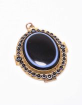 A late 19th century banded agate pendant with locket reverse