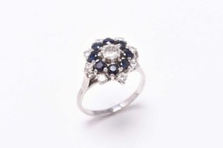 A sapphire and diamond circular cluster ring