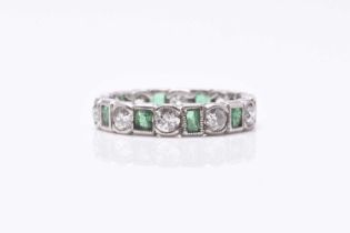 An emerald and diamond eternity ring