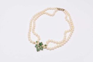 A two strand cultured pearl necklace with emerald and diamond set pendant