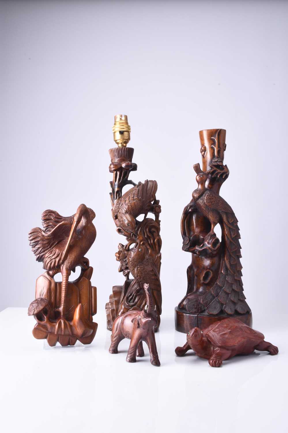 Two Chinese carved hardwood figural lamp bases and three small wood carvings