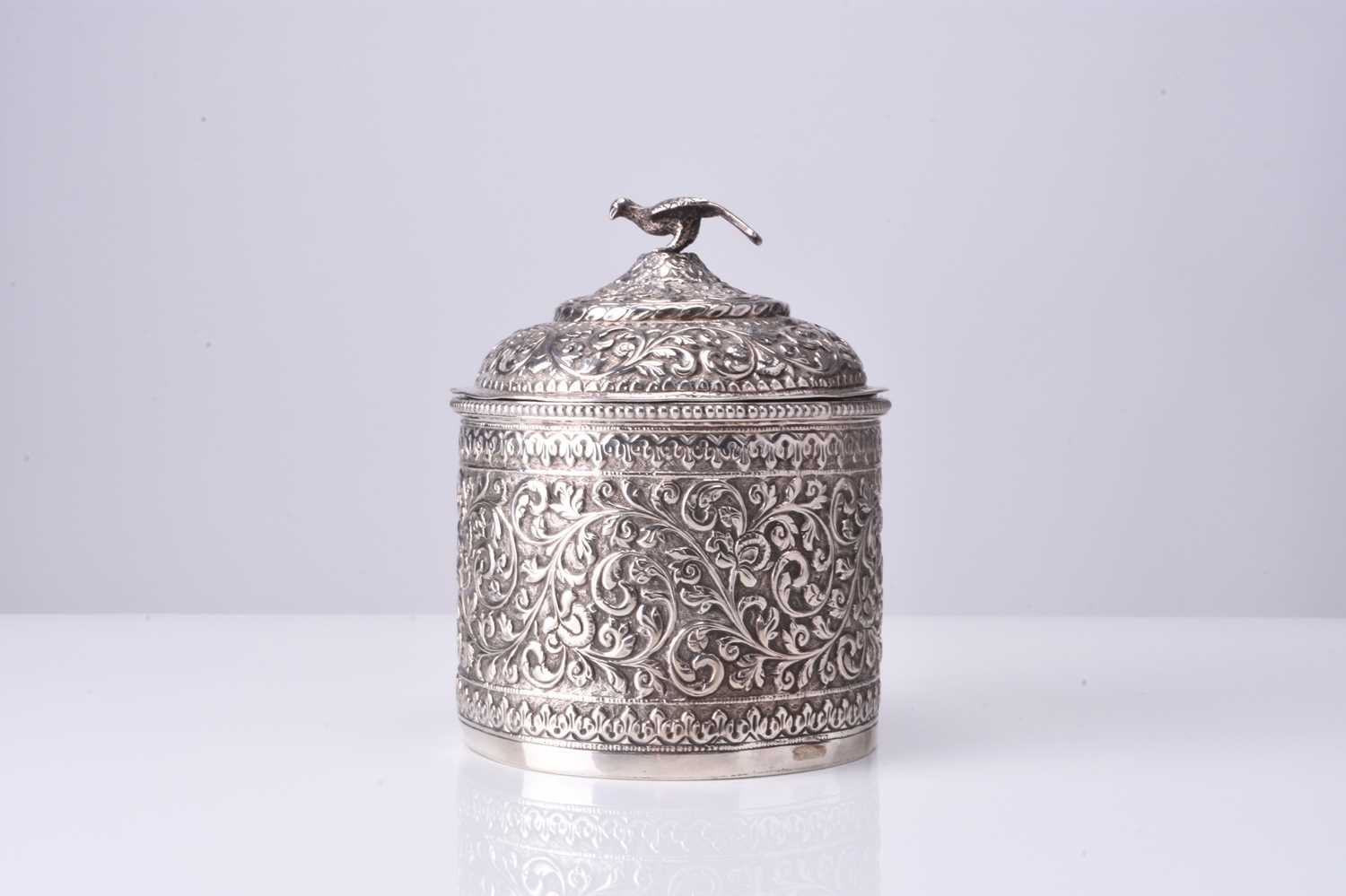 An Indian embossed silver powder box and cover, 19th century