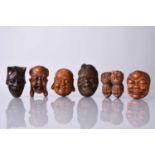 A group of six Japanese wood netsuke of masks, 20th century