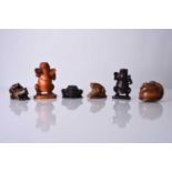 A group of six Japanese wood netsuke of frogs and toads, 20th century