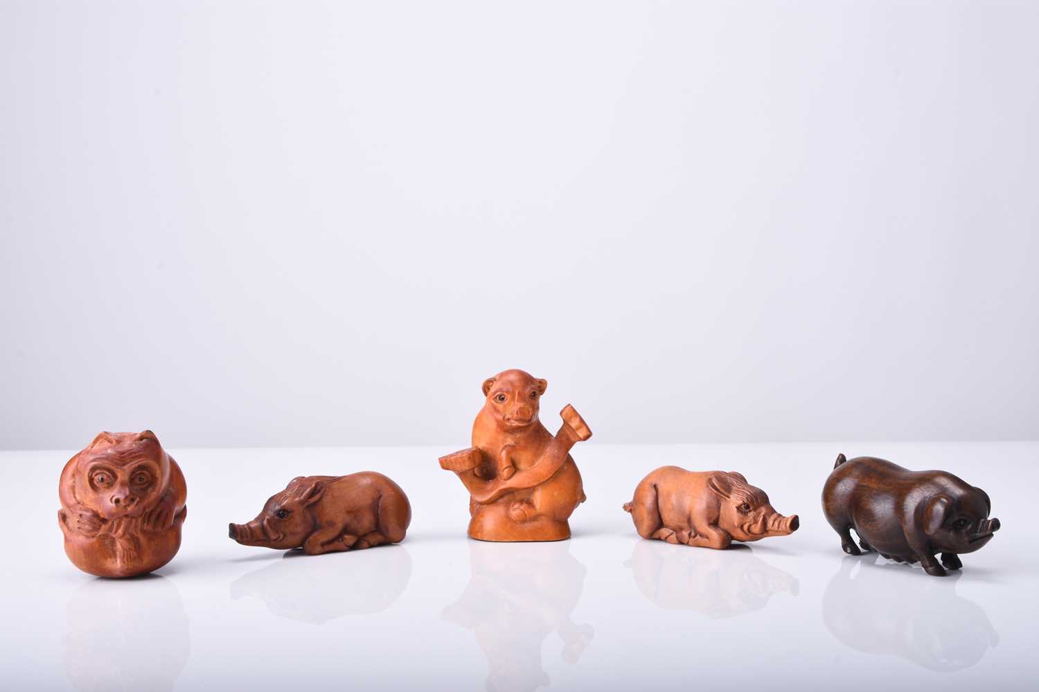 A group of five Japanese wood netsuke of pigs and boars, 20th century