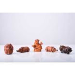 A group of five Japanese wood netsuke of pigs and boars, 20th century