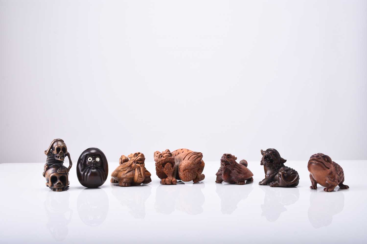 A group of seven Japanese wood netsuke of mythical creatures, 20th century