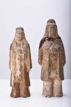 Two Chinese buff pottery attendant figures, Tang Dynasty
